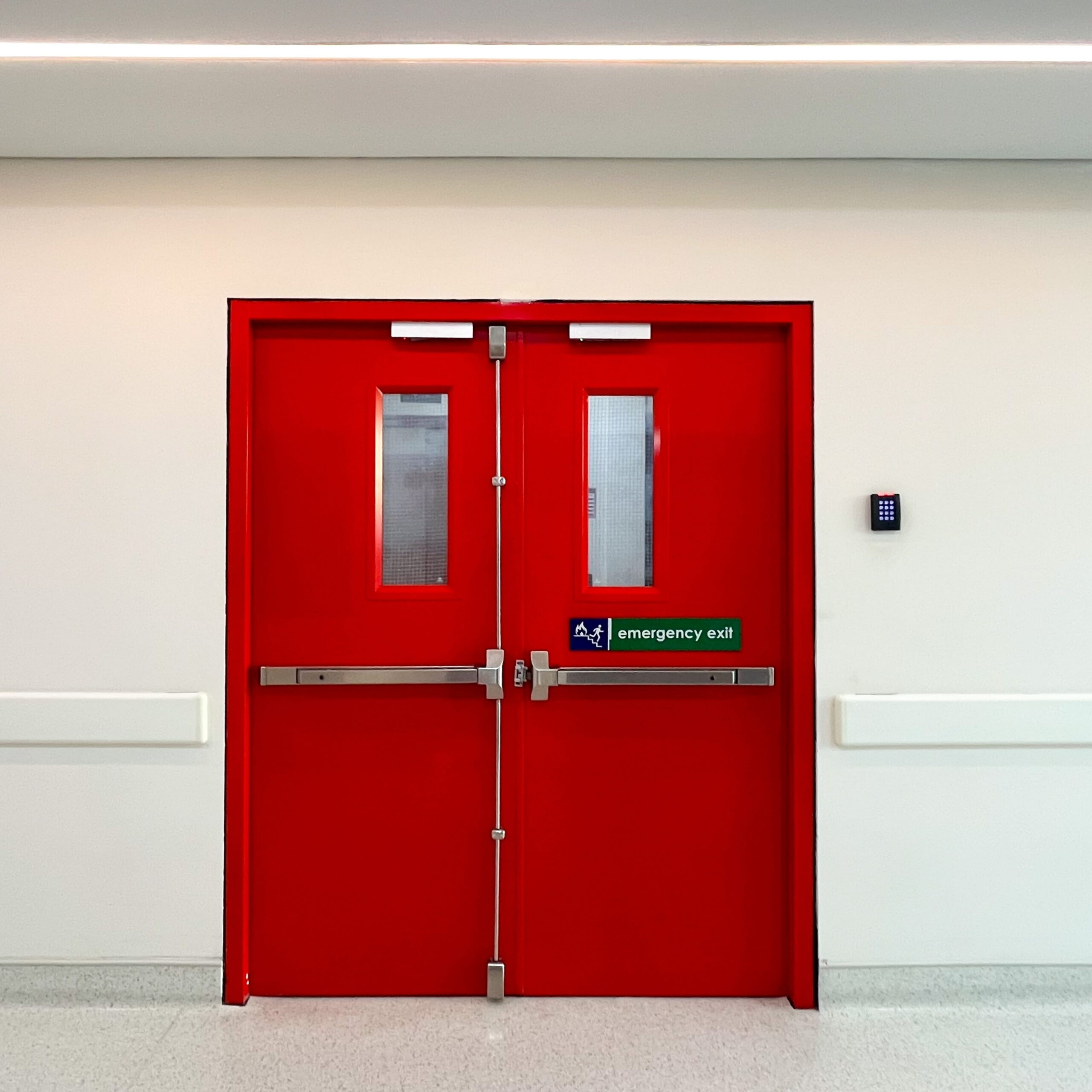 A composite view showing a red emergency exit door with a crash bar and a blue louvered utility door for schools.