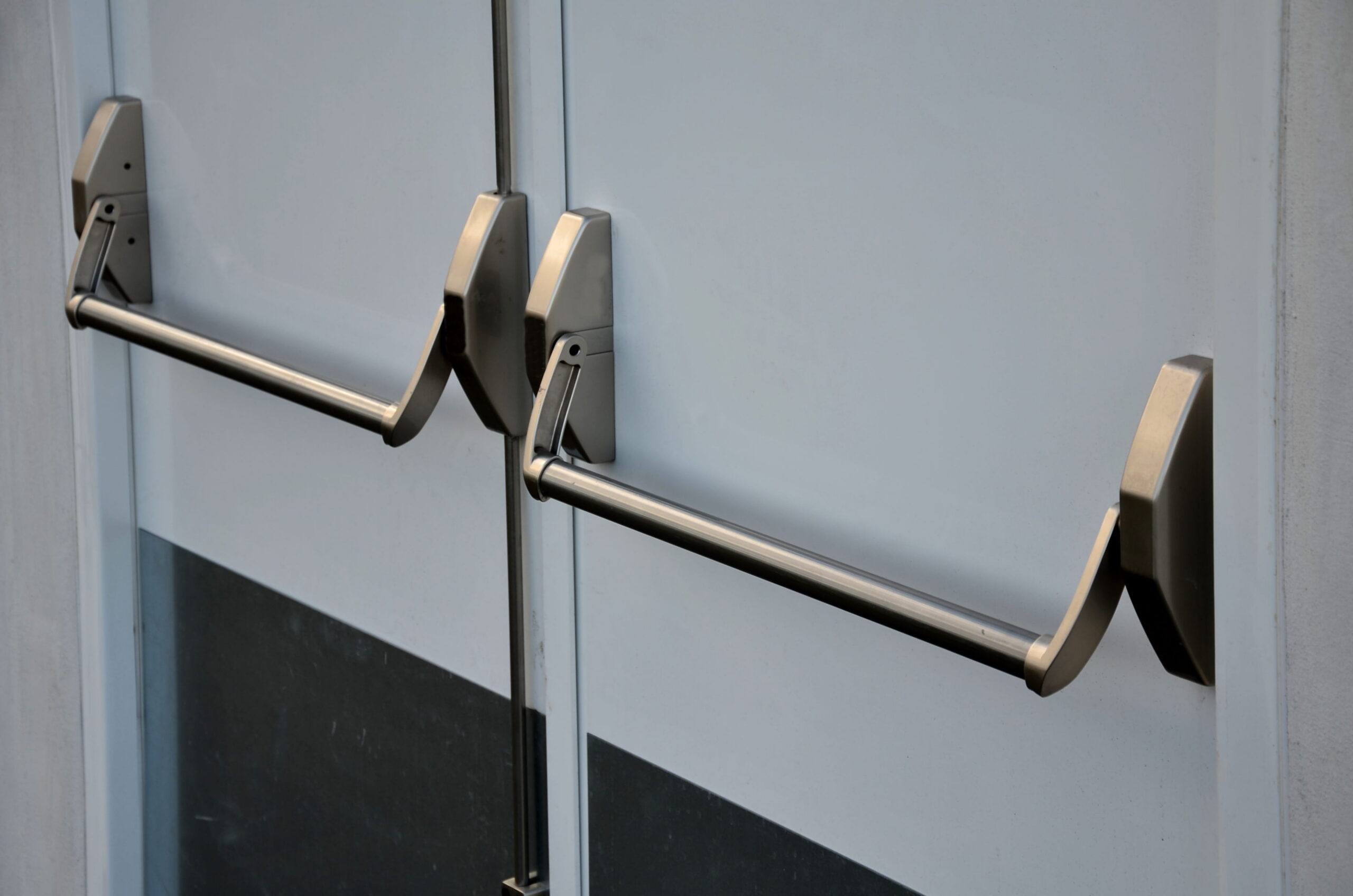 Professional installation of a made-to-measure external steel door on a high-traffic commercial building.